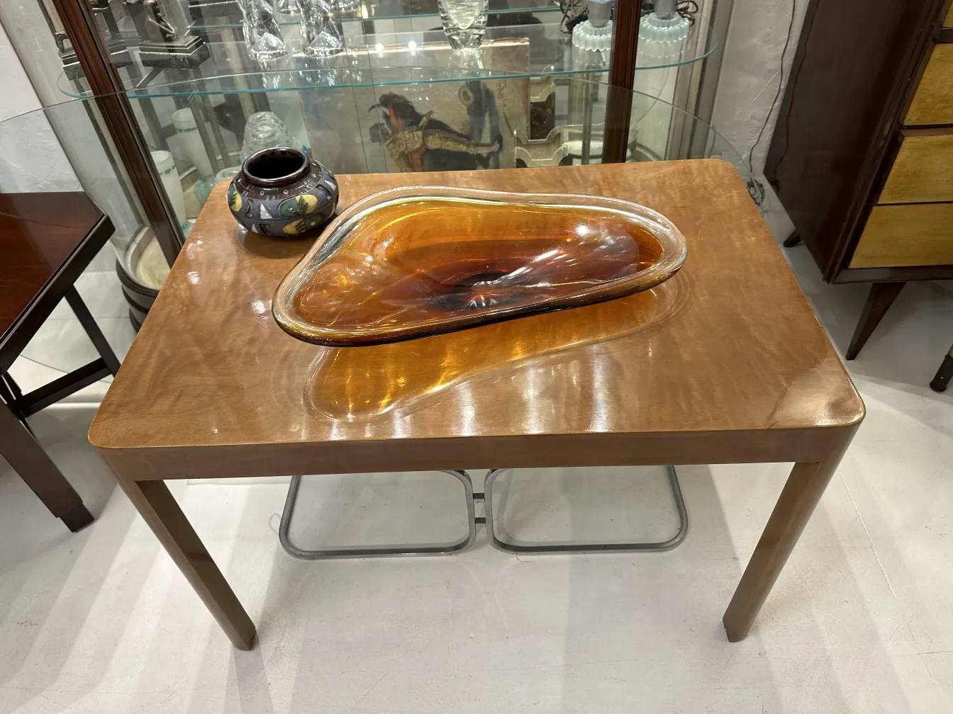 Elegant antique artisanal ceramic on a glossy table.