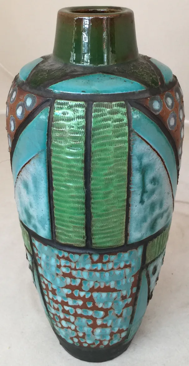 Antique ceramic vase in green and blue tones with artistic design.