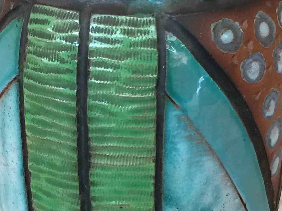 Antique decorative ceramic in green and turquoise tones. Features stylized details complementing the piece.