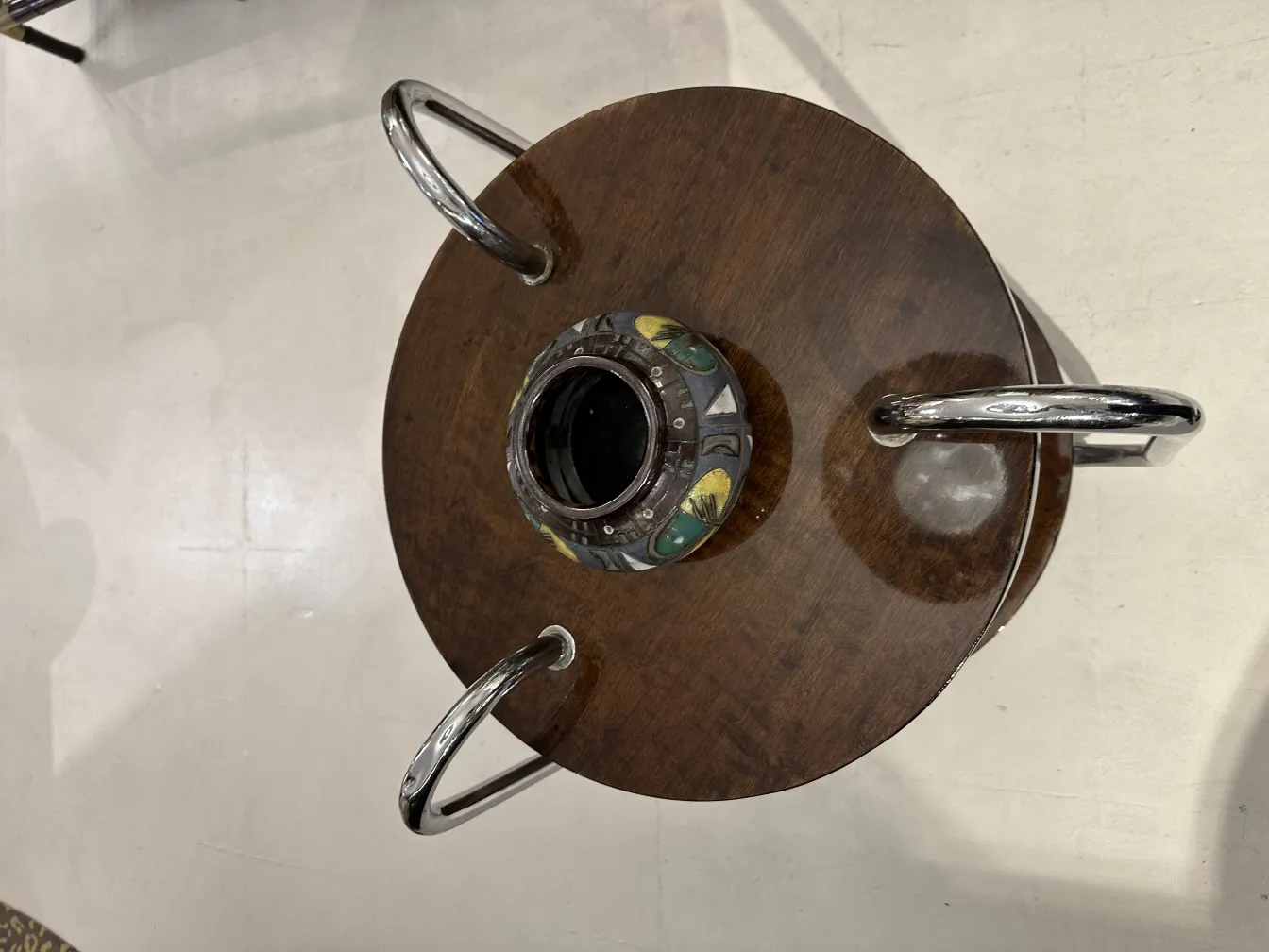 Antique ceramic piece with colorful details on a wooden table