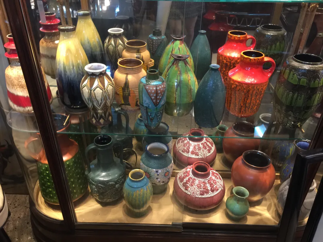 showcase with various pieces of antique decorative ceramic in colors