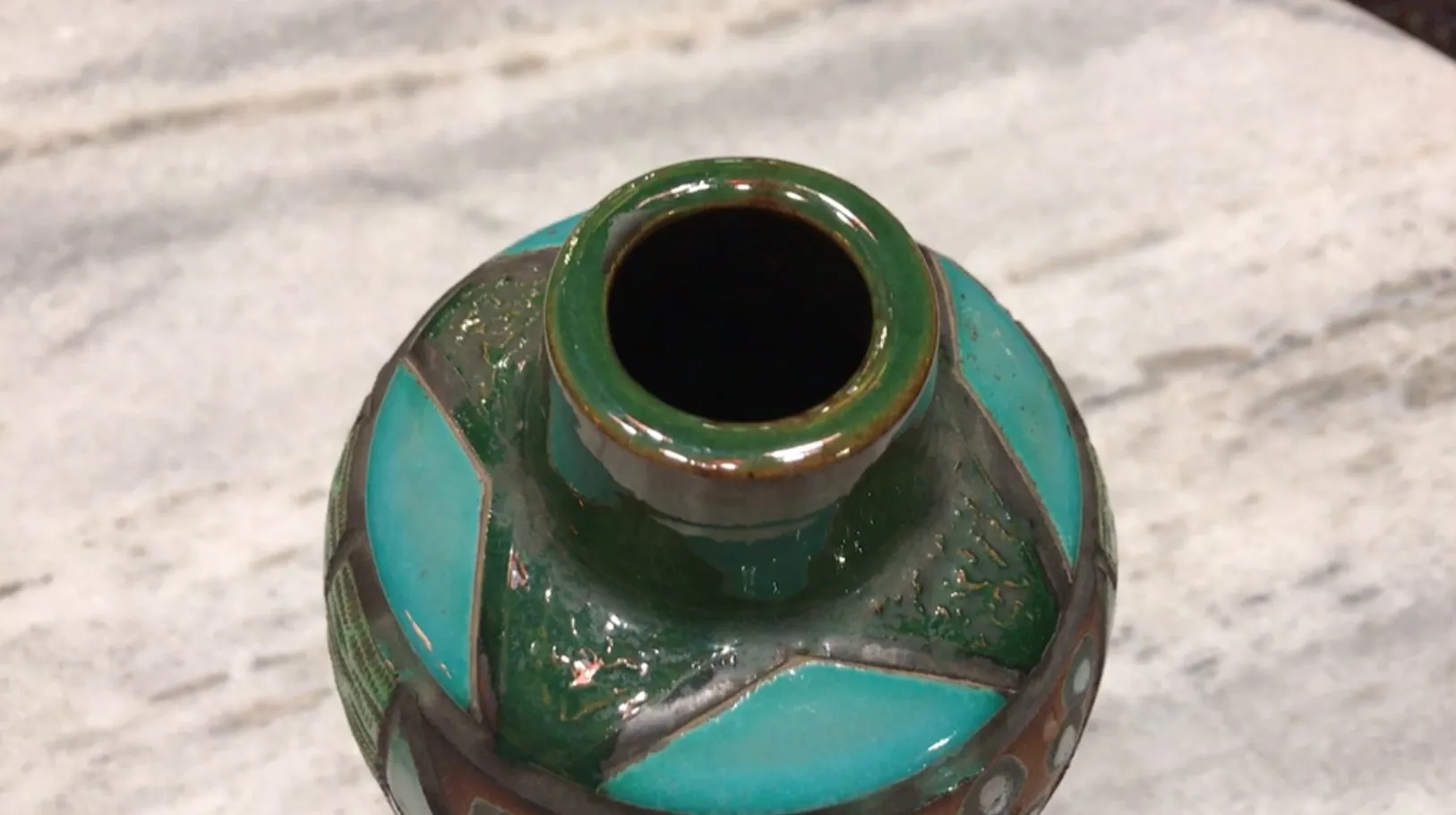 Top view of an antique green ceramic with decorative details
