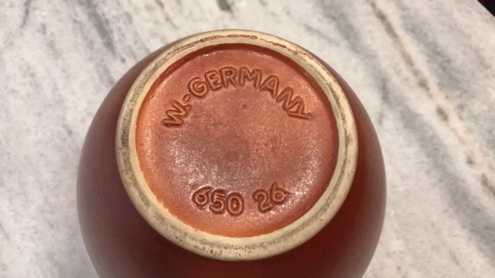 View of the bottom of an antique ceramic piece from Germany with inscriptions