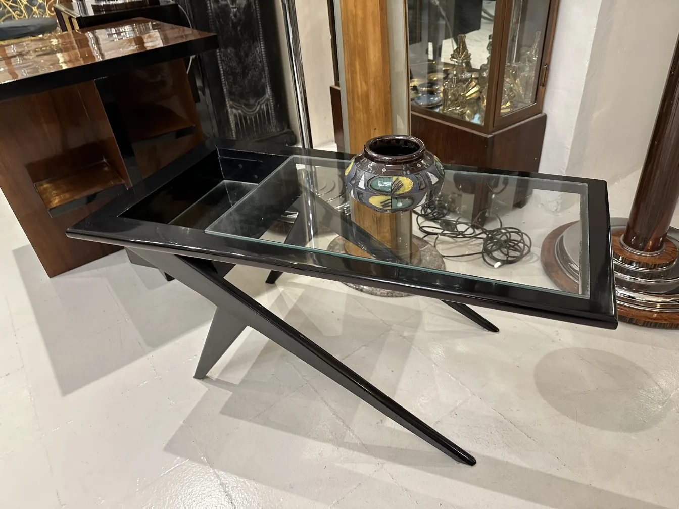 Decorative ceramic vase on a modern glass table.