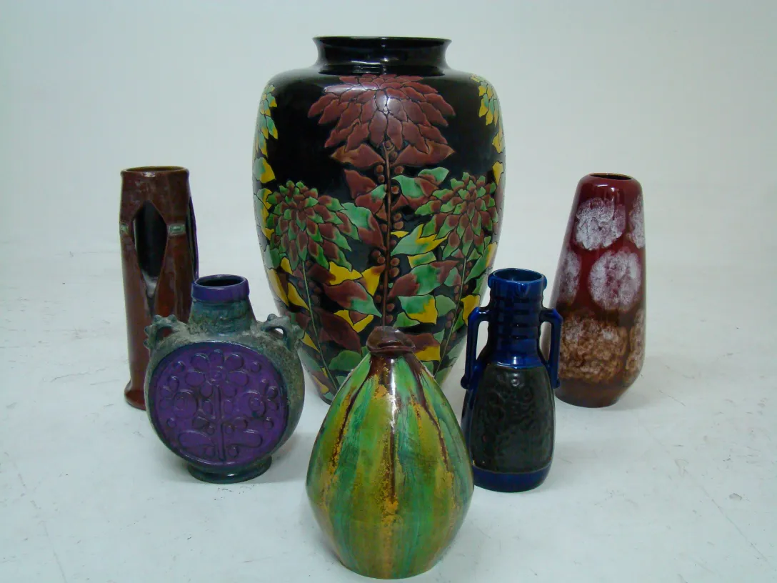 A variety of antique decorative ceramic in different colors and shapes.