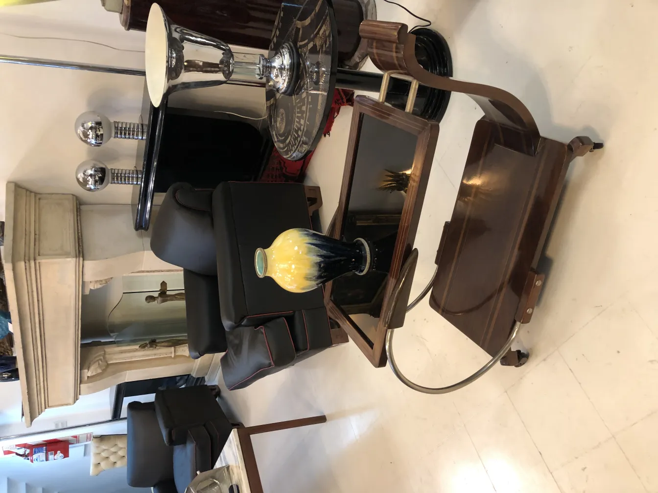 Antique ceramic vase in yellow and black in a stylish setting