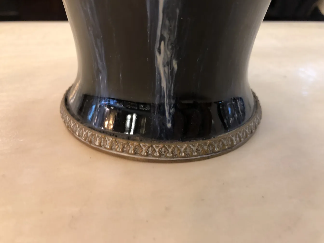 Base of antique ceramic with decorative golden detail.