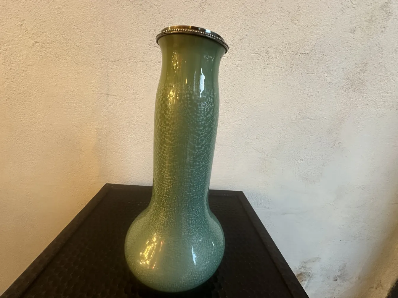 Antique green ceramic vase with shiny details
