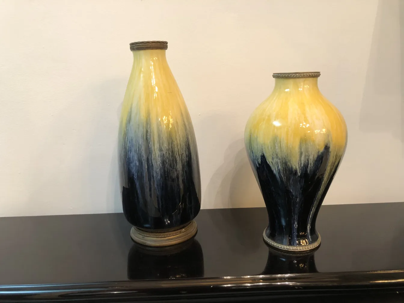 Two antique ceramic vases in yellow and blue hues