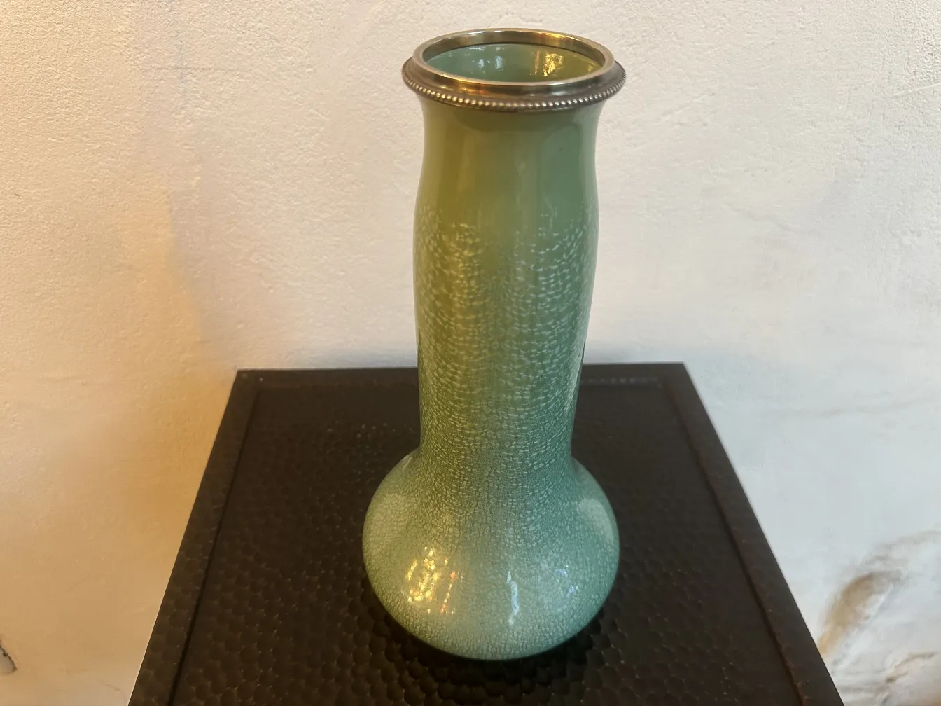 Antique green ceramic vase, stylish and decorative, with a sturdy base.