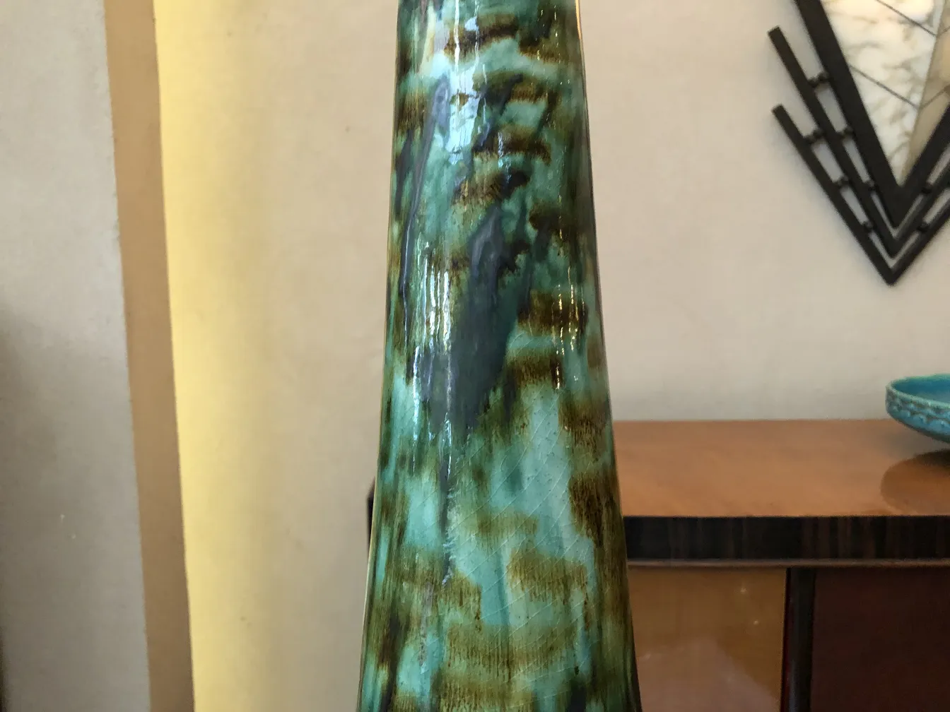 Antique ceramic figure in emerald tones with unique textures.