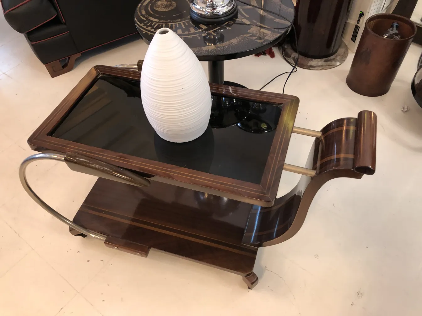 White ceramic vase on an antique wooden table with elegant design