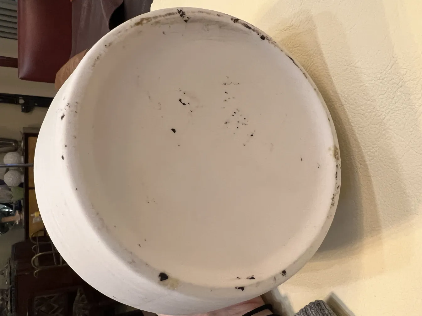 Antique ceramic plate, white surface with usage marks.