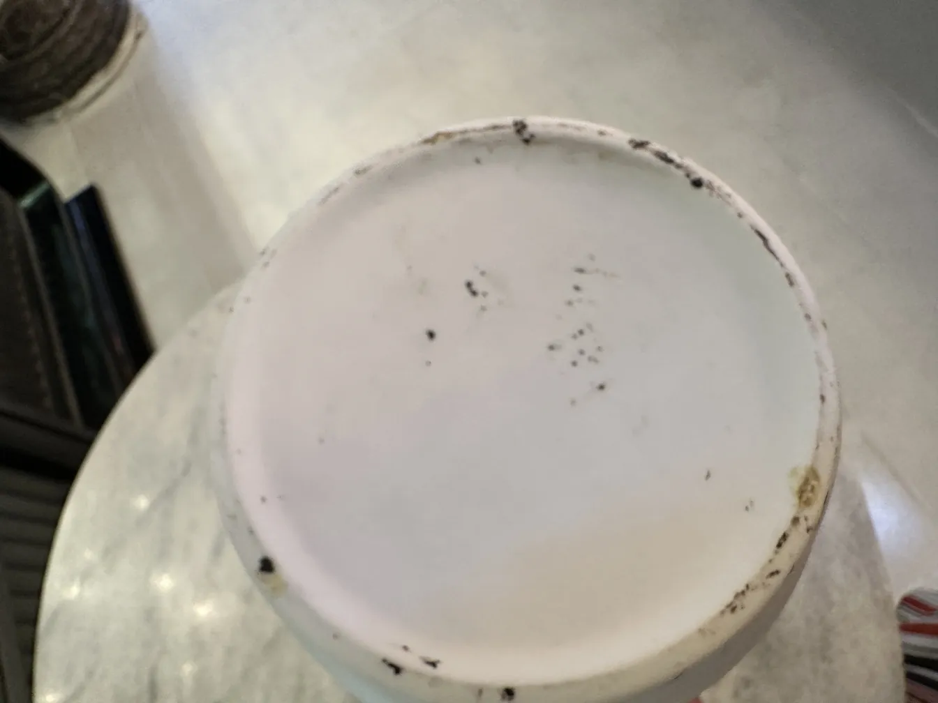 Top view of an antique white ceramic with stains