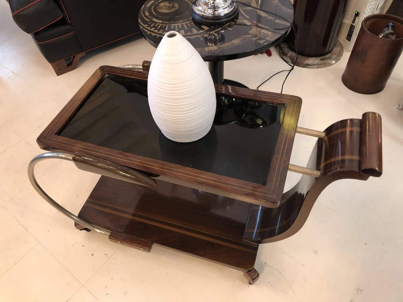 White ceramic vase on dark wood table