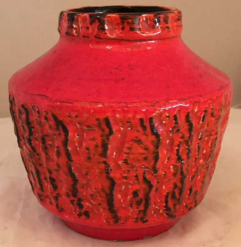 Antique red ceramic vase with unique texture.