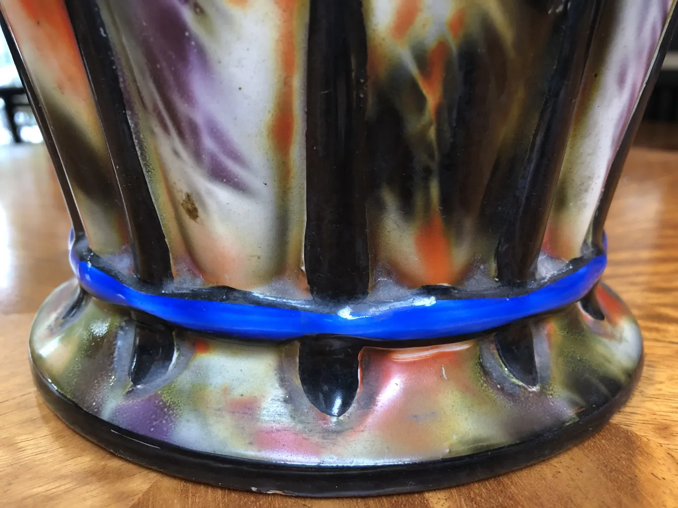 Base of antique ceramic with colorful patterns and shine