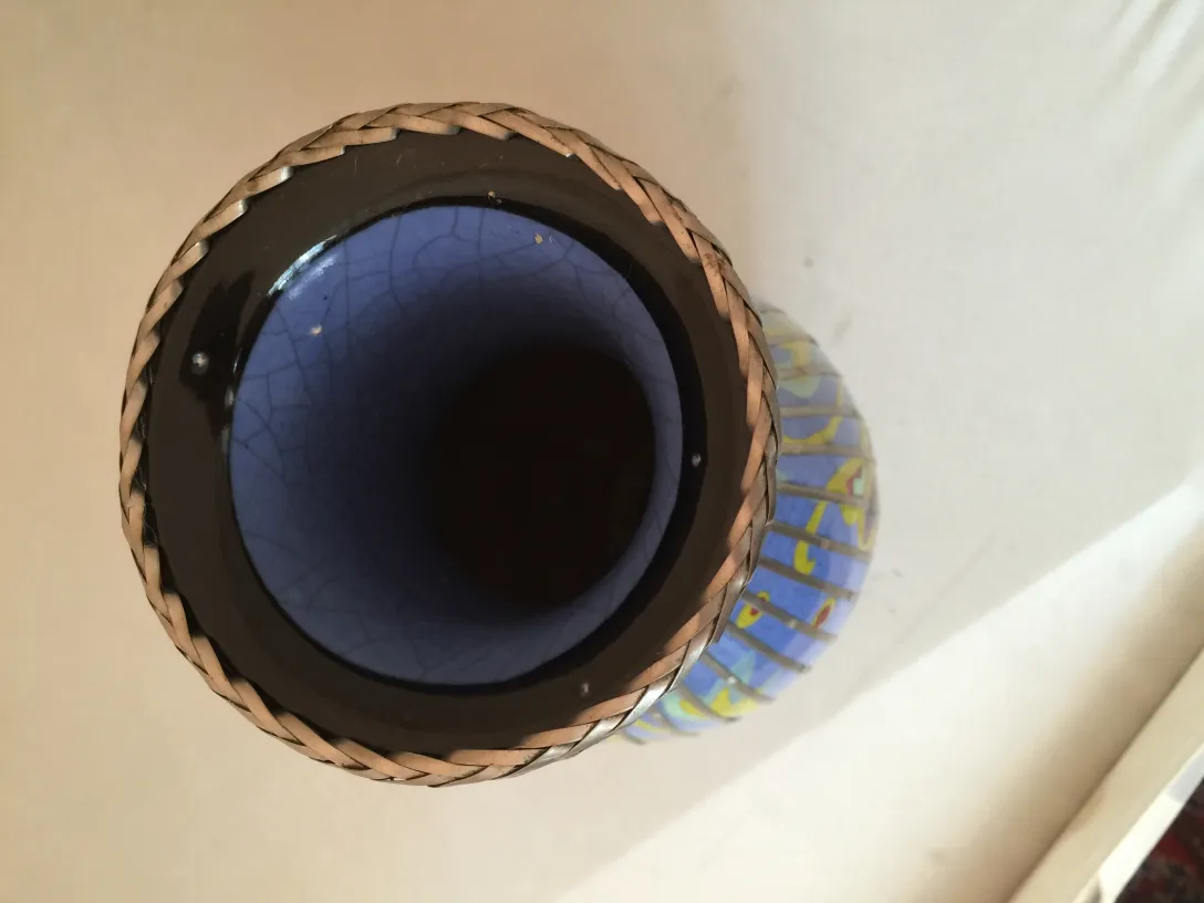 Antique ceramic vase with colorful design and braided edge