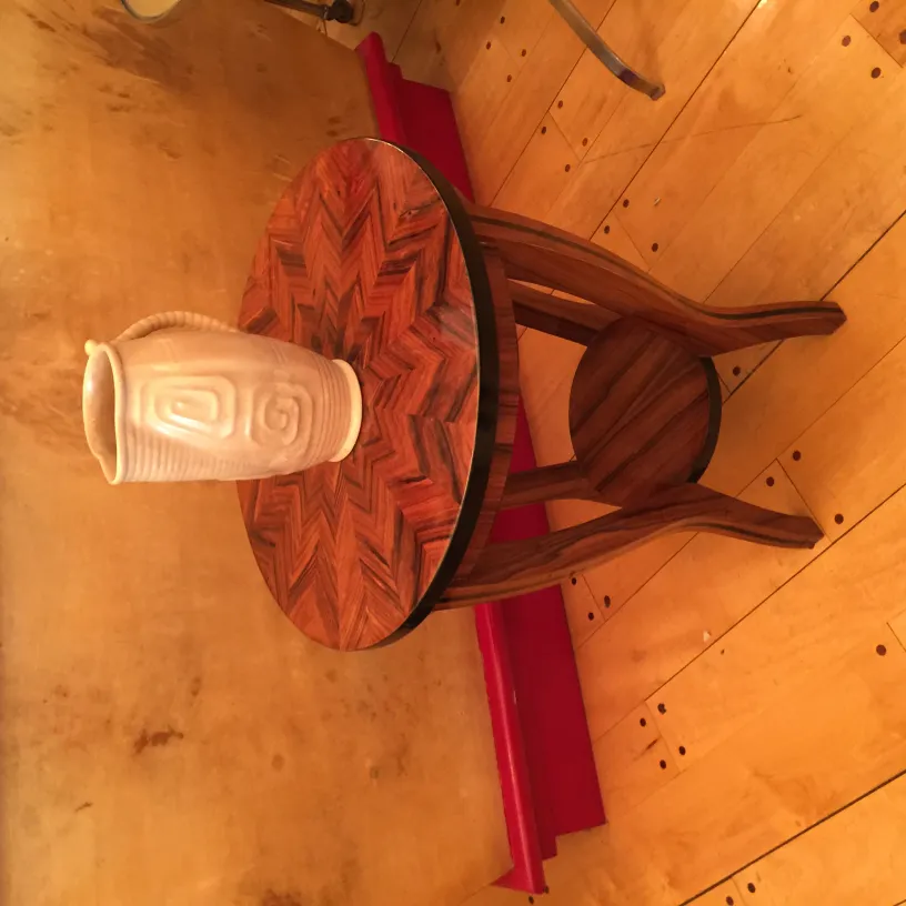 Antique ceramic vase on patterned wooden table