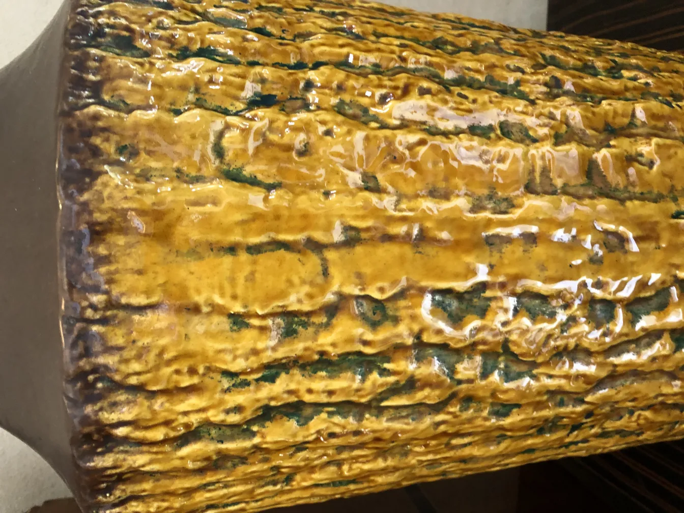 Antique ceramic with glossy yellow and green texture.