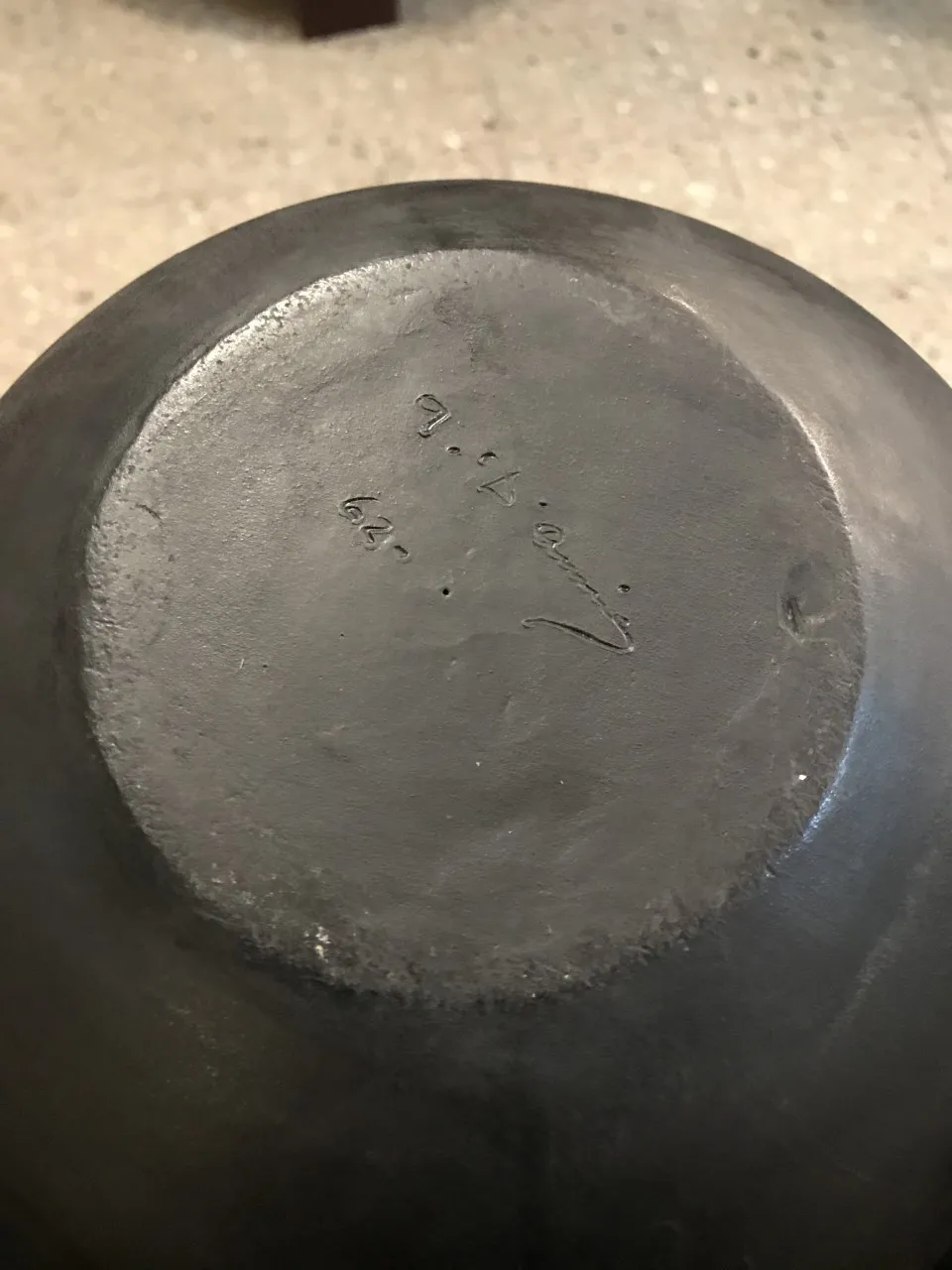 Antique ceramic with decorative details on the base, visible signature.