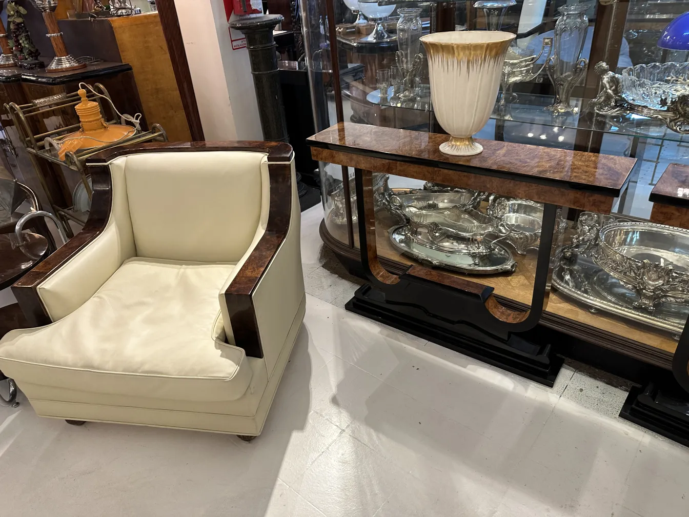 modern armchair with antique decorative ceramics in the background