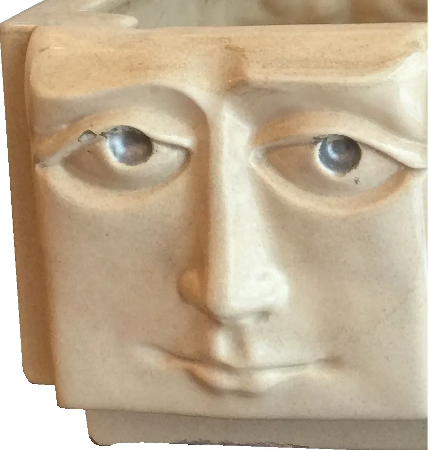 Antique ceramic container with sculpted face, light color