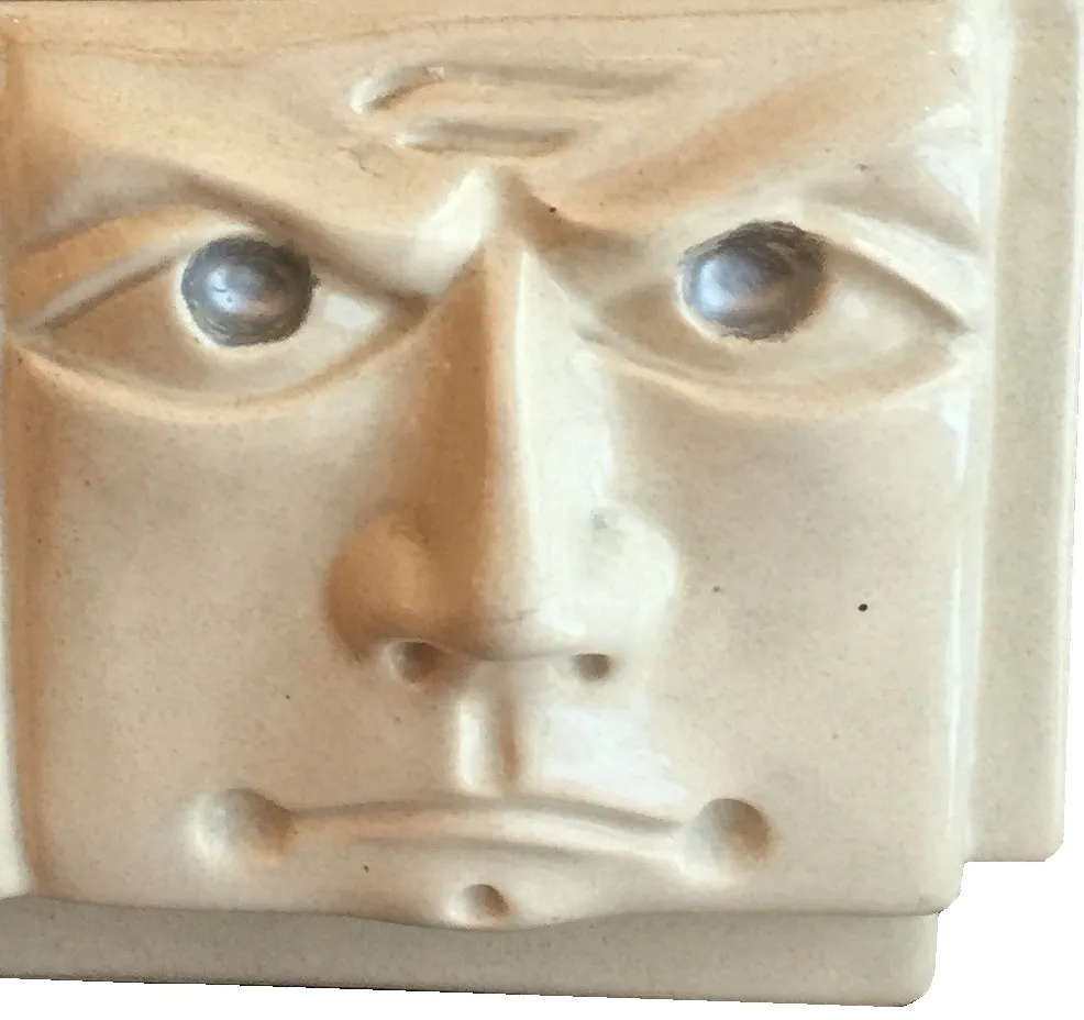 Antique ceramic with a face, unique and distinct in light colors