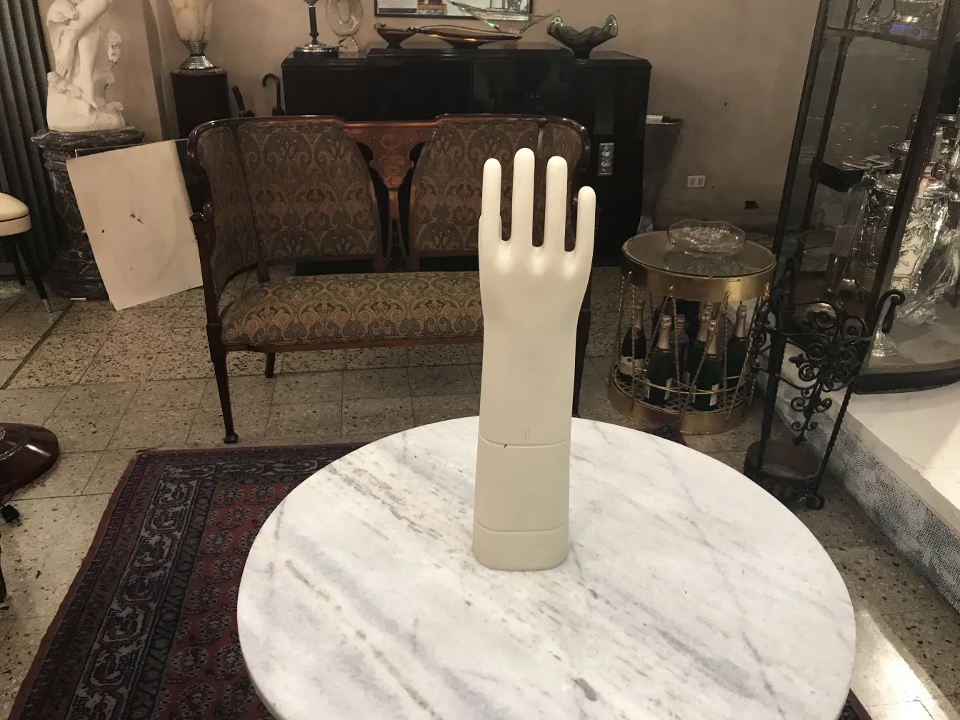 Antique ceramic hand model on marble table