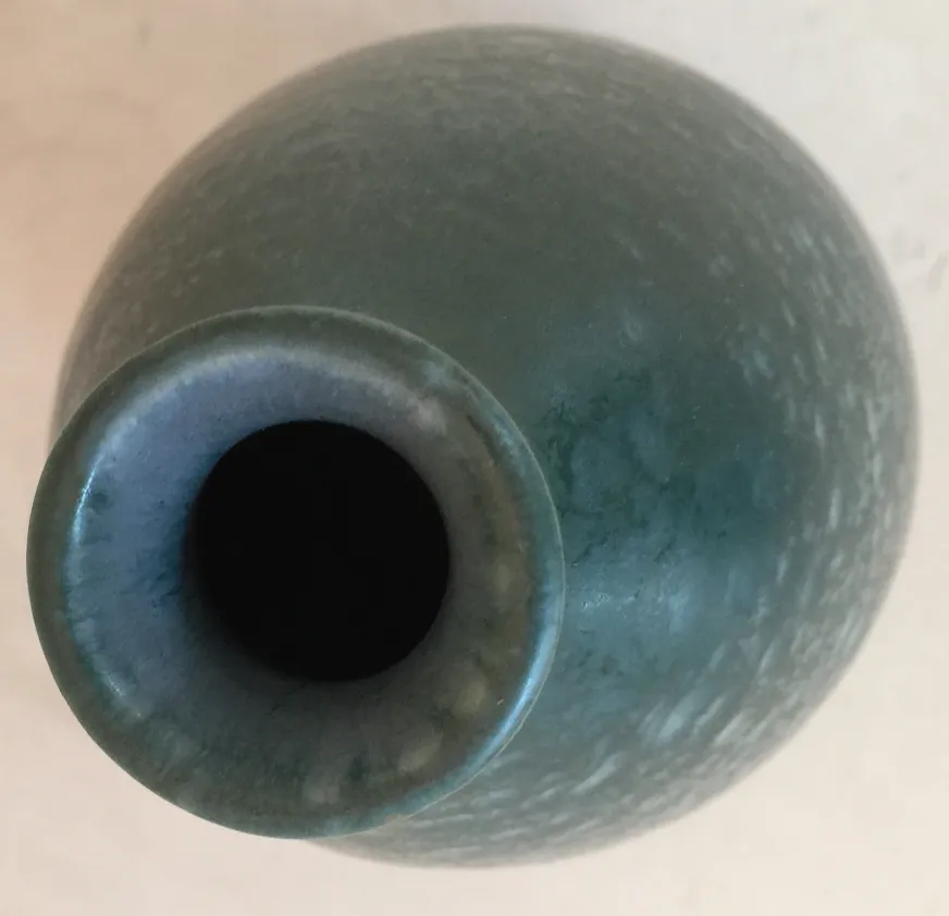 Antique ceramic vase in emerald green color.