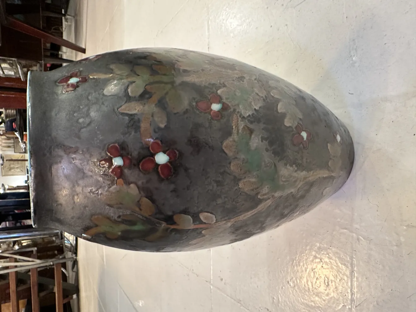 Antique ceramic vase with floral details and soft colors