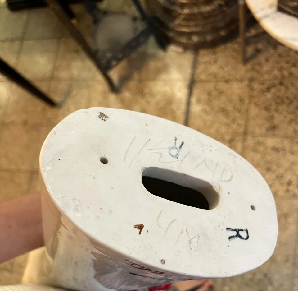 Top view of an antique ceramic piece showcasing unique details and markings.