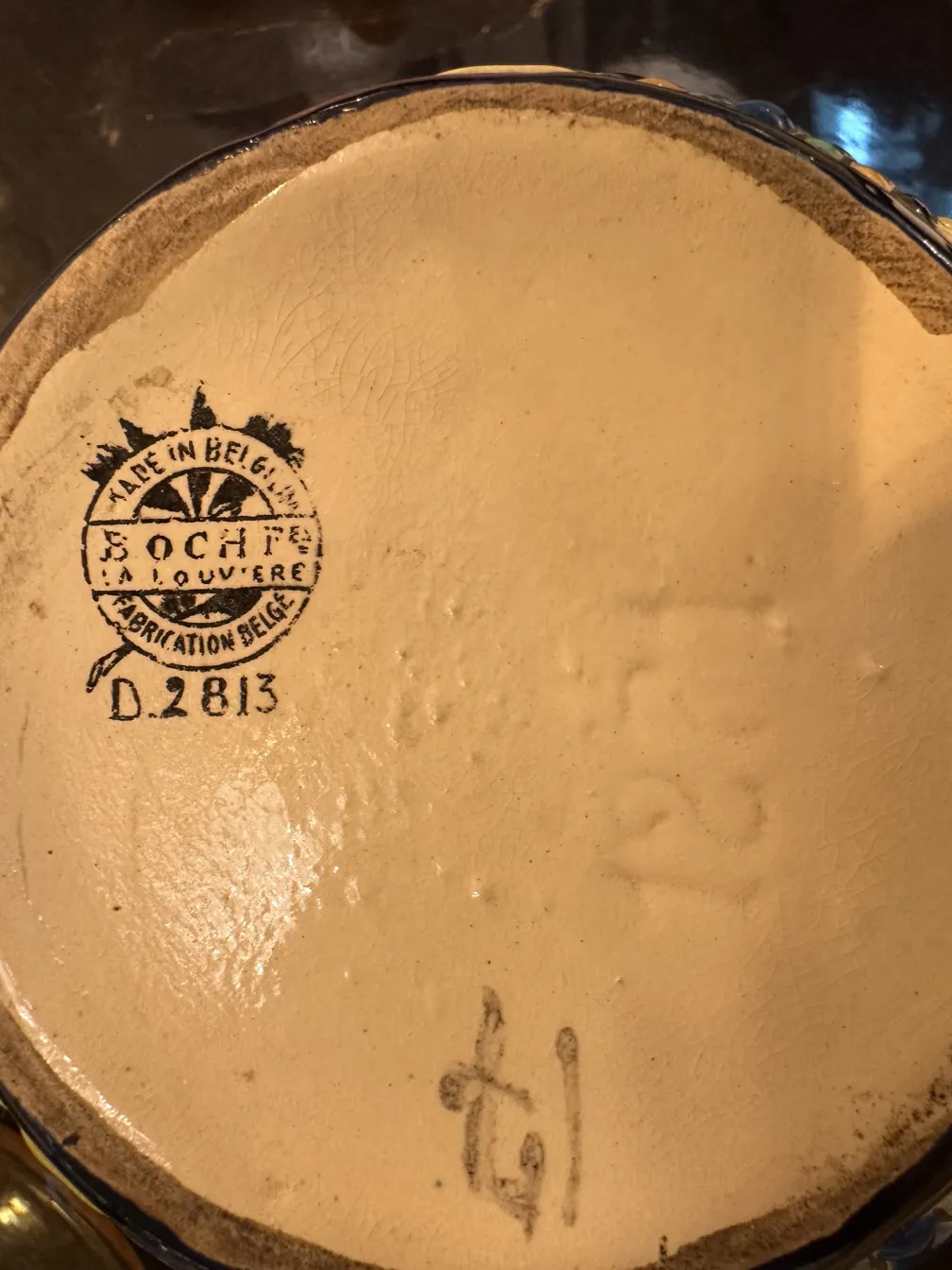 Antique Belgian ceramic with distinctive stamp and visible details.