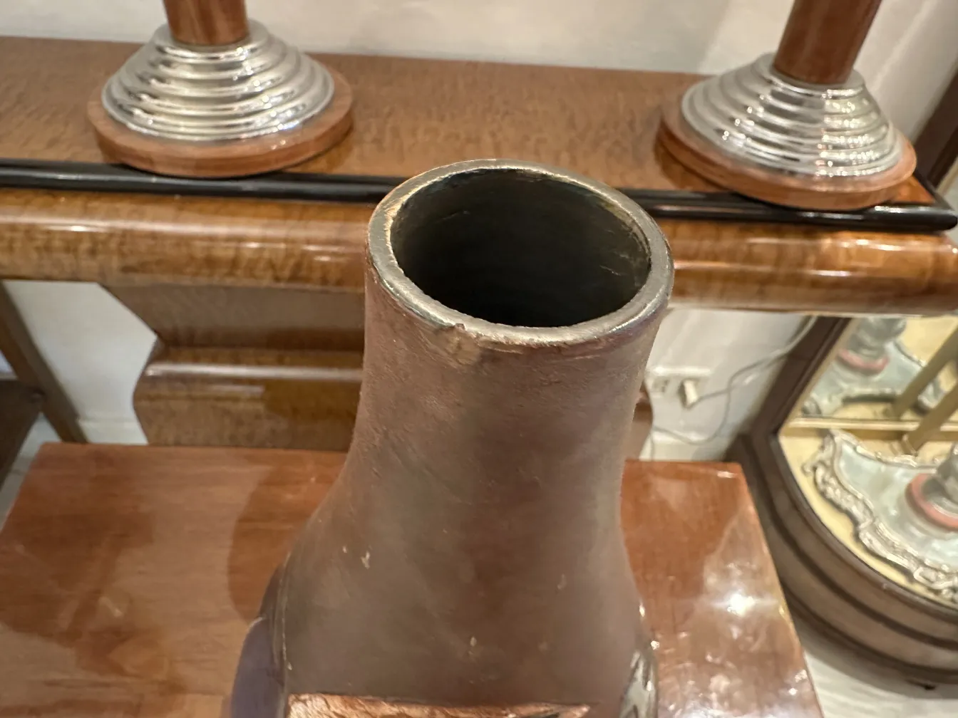 Antique ceramic vase with rustic finish, subtle decorations in a cozy setting.