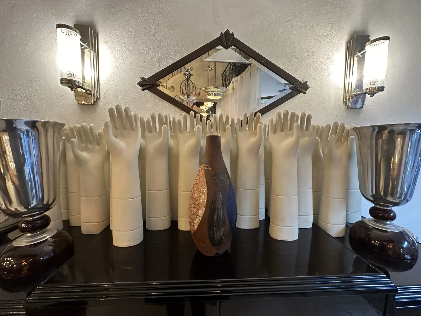 Antique ceramic vase with a stylized shape, set against a decorative background.