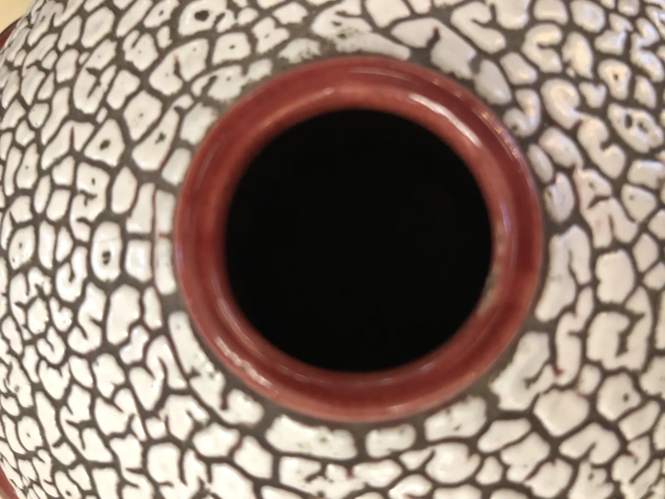 Antique ceramic piece featuring terracotta highlights and a charming crackle pattern.