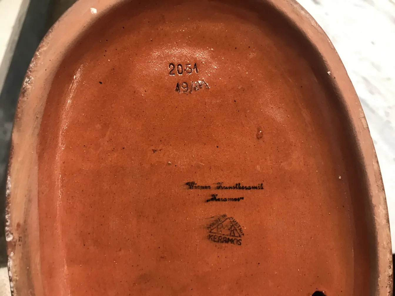 antique ceramic with markings on base, terracotta color, simple style