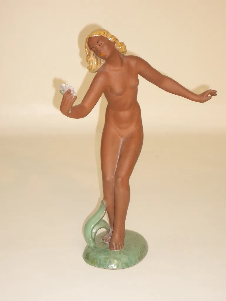 Antique ceramic figure representing a woman in a neutral setting