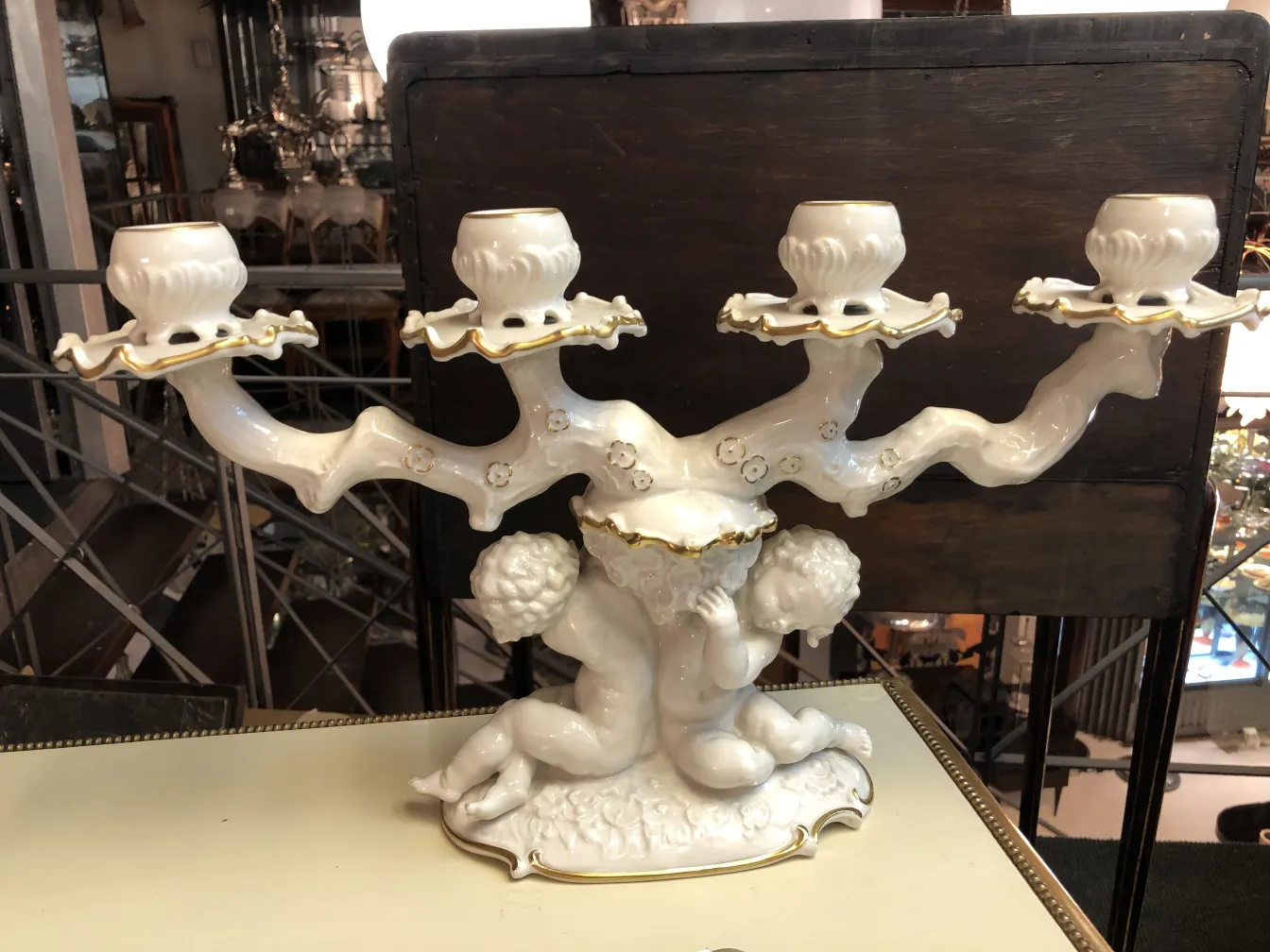 Antique ceramic candelabrum with ornate details.