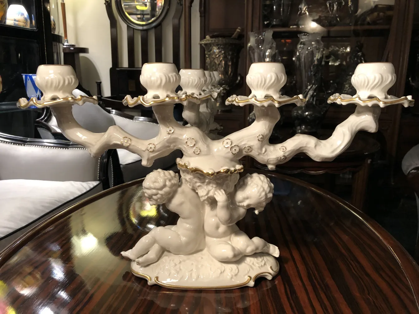 Antique ceramic candleholder with gold accents and figures
