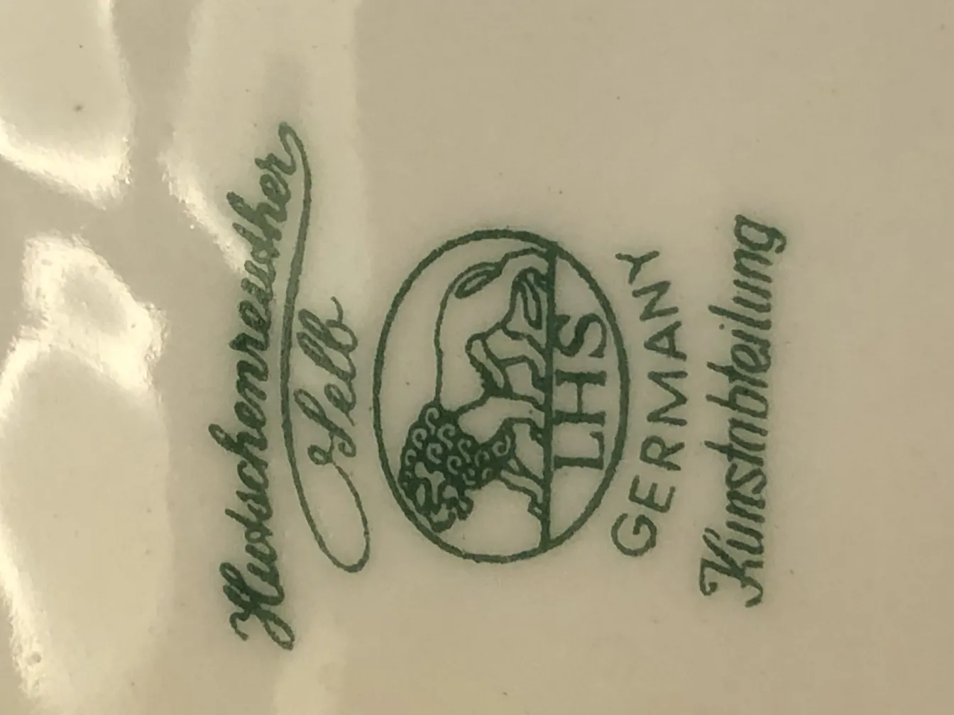 Antique ceramic with green marking and German details.