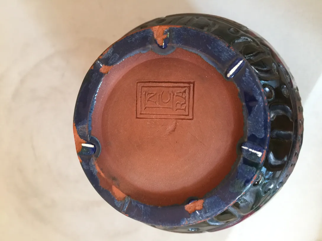 View of the bottom of an antique ceramic with visible details