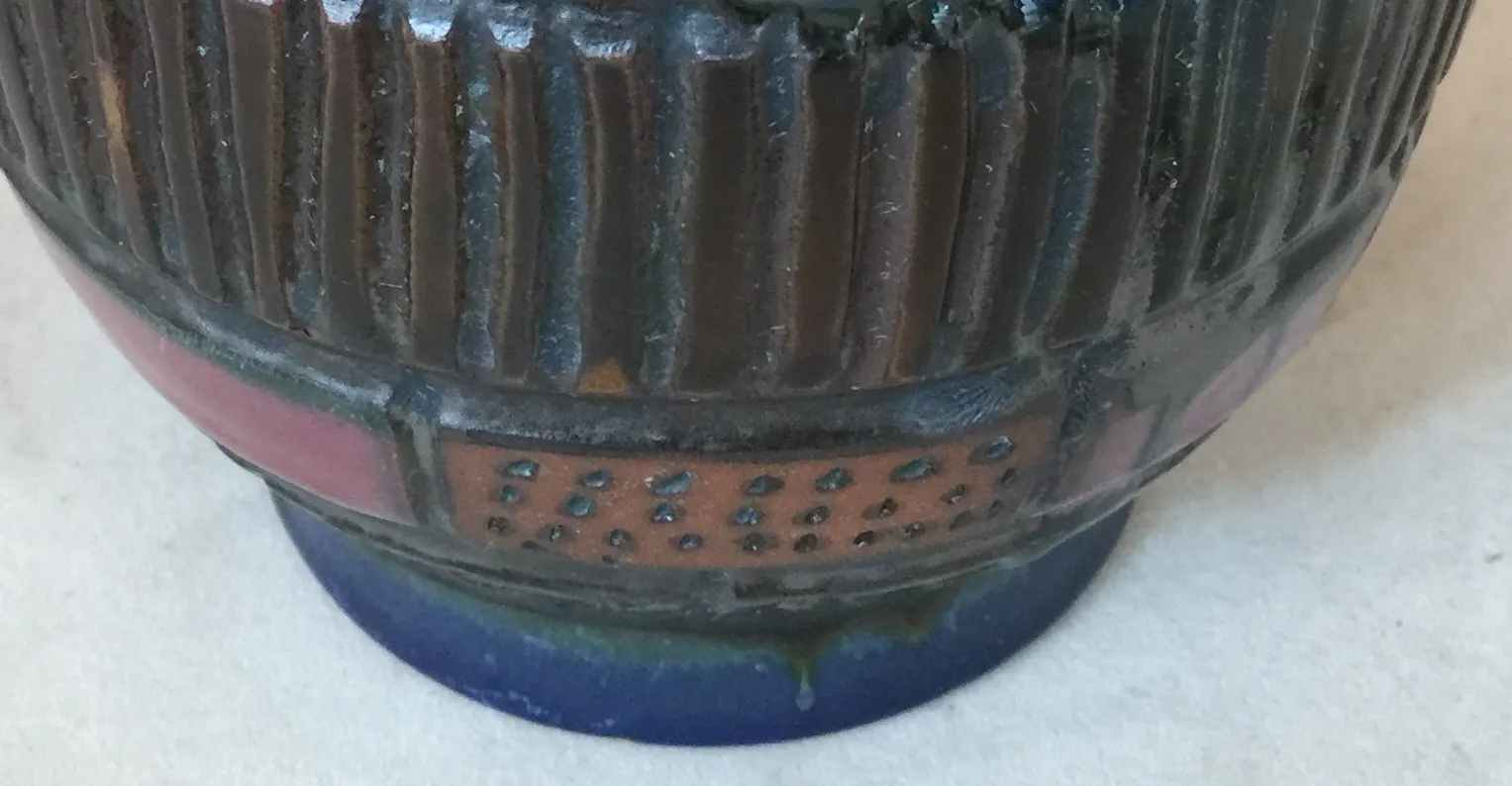 antique ceramic vase with colorful and textured decorations