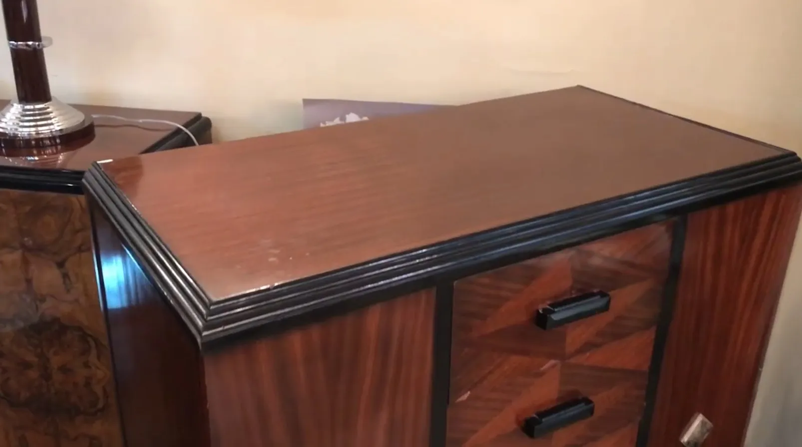 Antique wooden cabinet with a glossy finish, elegant details.