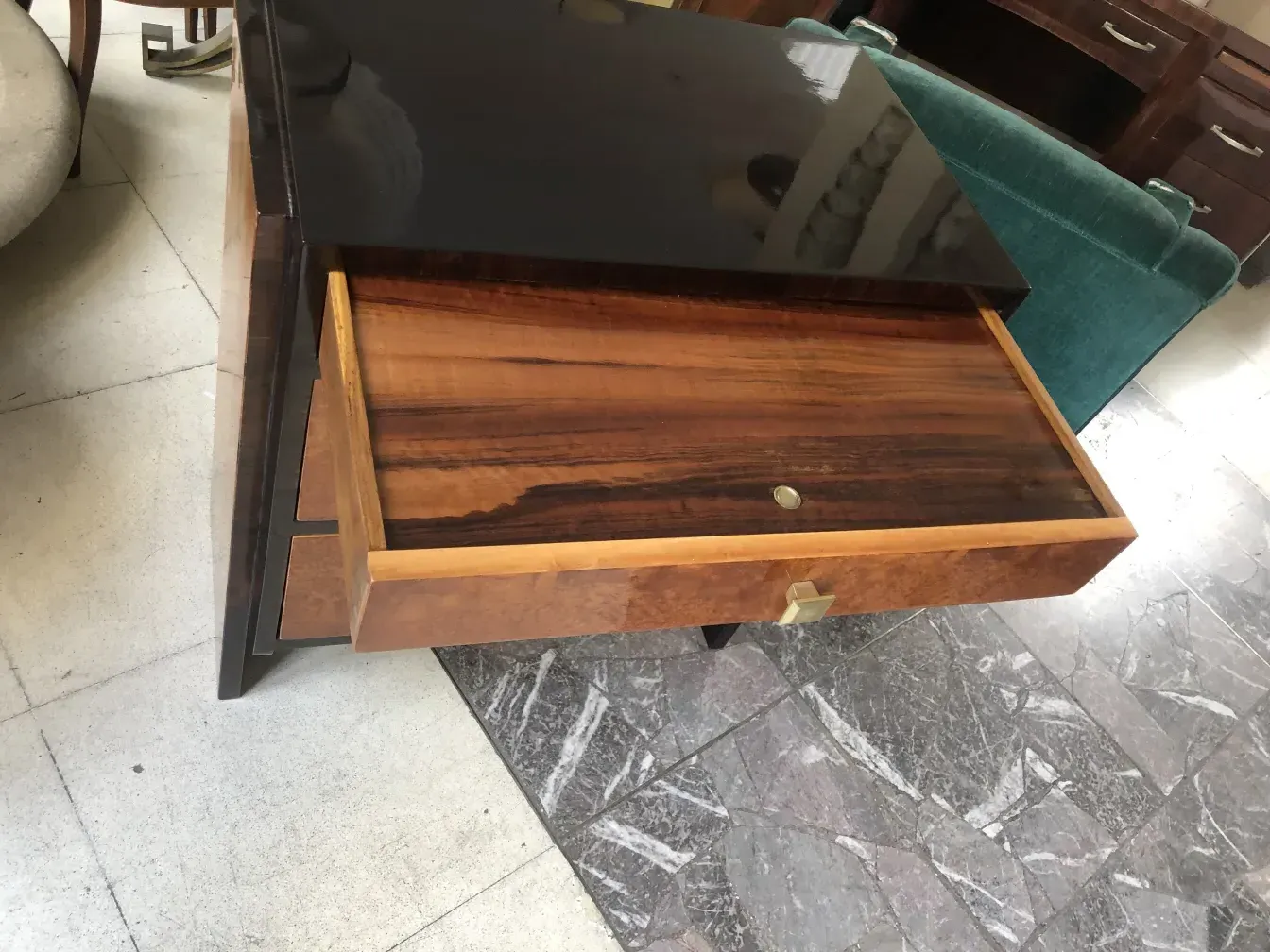 Antique wooden cabinet with two open drawers, elegant setting.