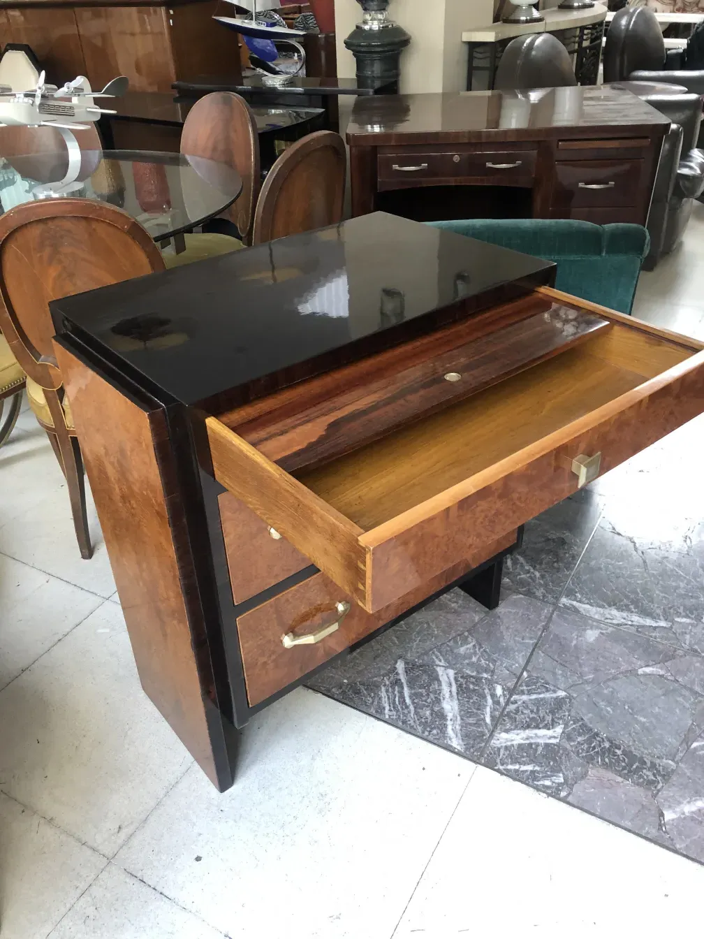 Antique cabinet with brown color and elegant design, surrounded by furniture.