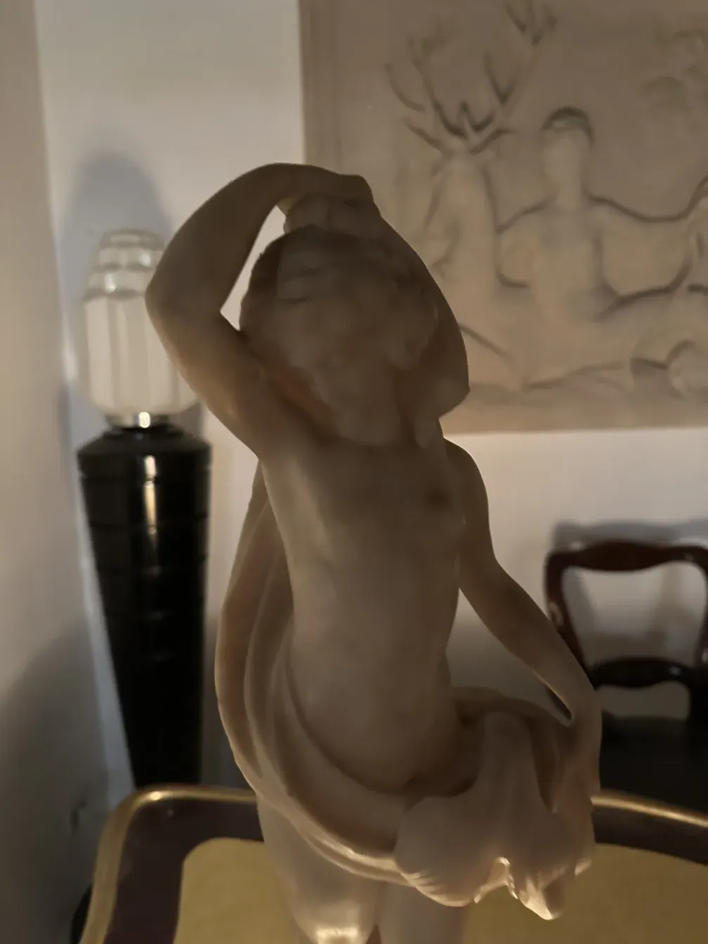 Классическая скульптура с человеческой фигурой в деталях, мягкий фон.