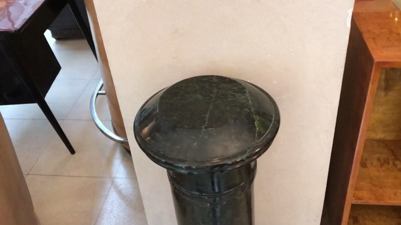 Antique dark green column with a decorative finish.