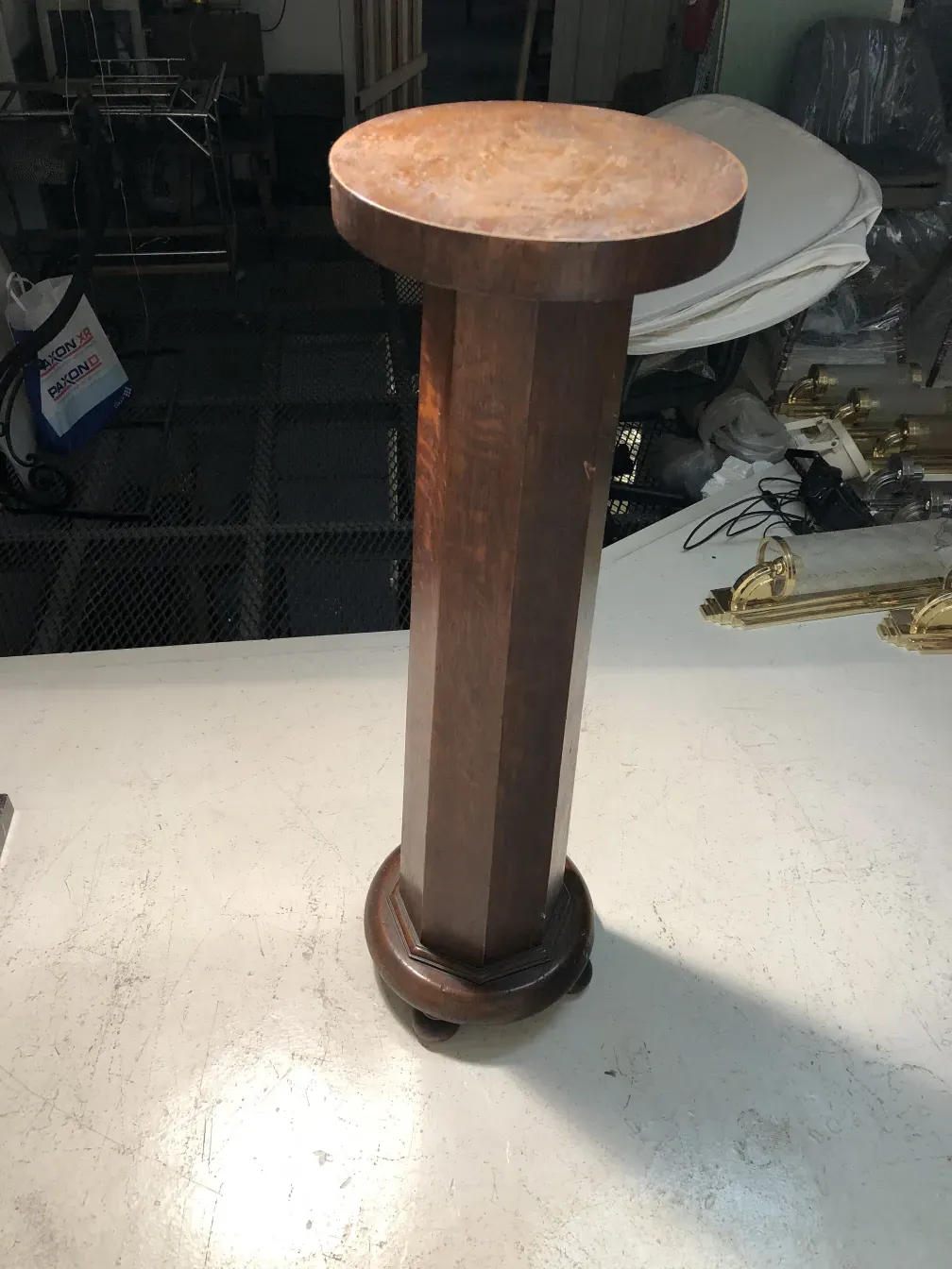 antique column with a circular decorative base in a neutral setting