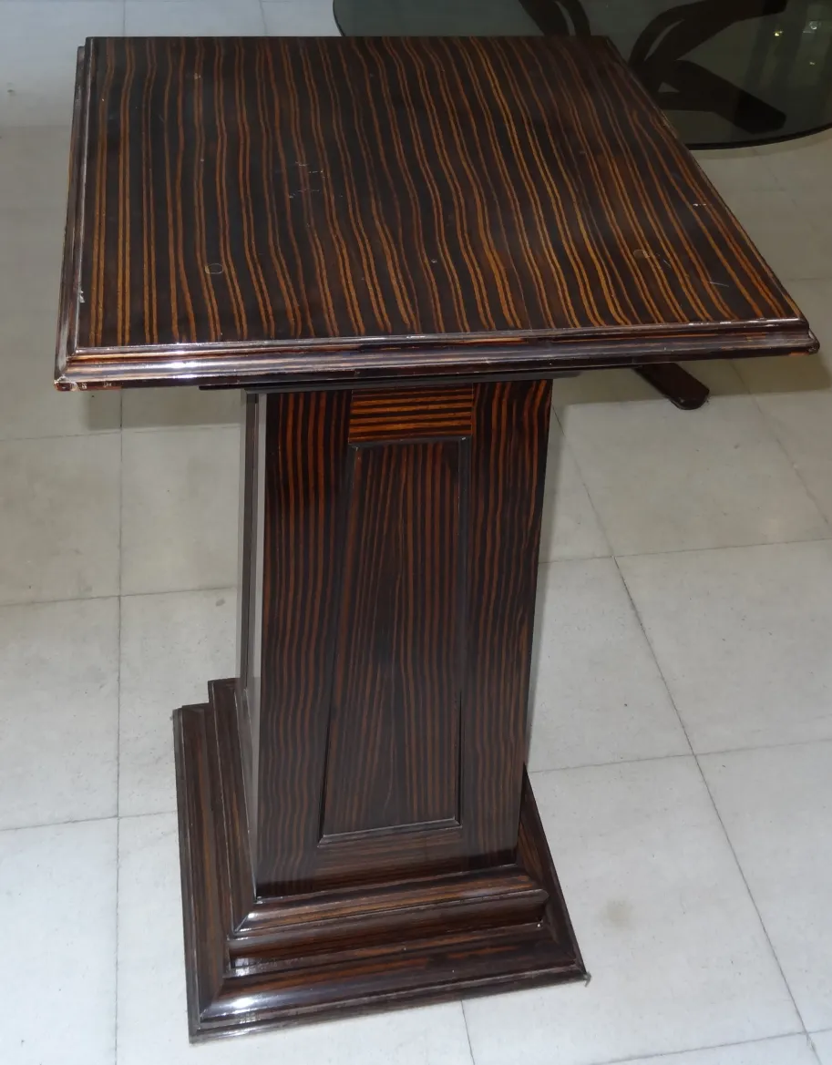 antique column with decorative details and solid base, elegant setting